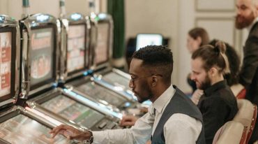 men playing slots in casino