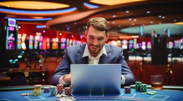 man on a laptop with a casino background